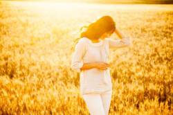 beautiful brunette lady in wheat field at sunset_shutterstock_197635442 676x451